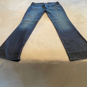 Size 29- dark blue jeans with a flare leg.